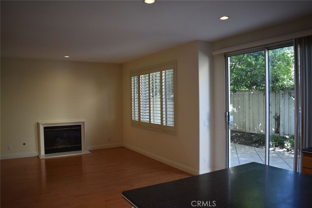 16 Del Ventura Irvine, CA 92606 - Photo 7 of 15 a view of an empty room with wooden floor and a window