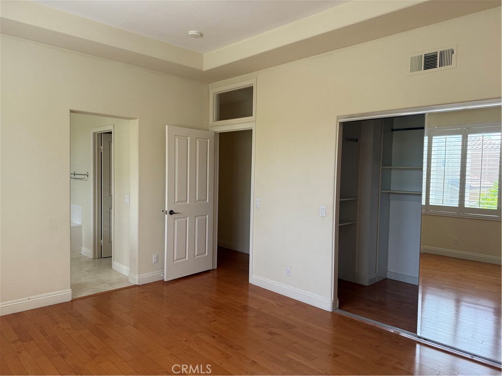 16 Del Ventura Irvine, CA 92606 - Photo 8 of 15 an empty room with wooden floor and windows