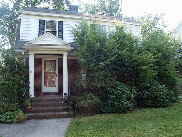 22 Arapahoe Road Newton, MA 02465 - Photo 1 of 13 a front view of a house with garden