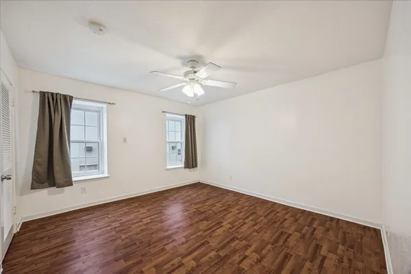 wooden floor in an empty room with a window