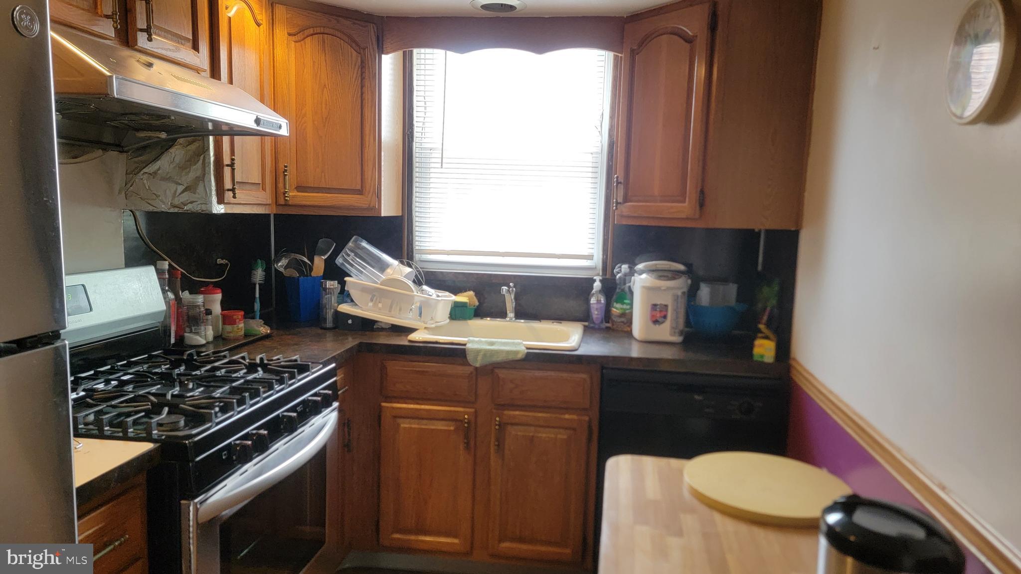 6024 Reach Street Philadelphia, PA 19111 - Photo 7 of 18 a kitchen with a stove a sink and a microwave