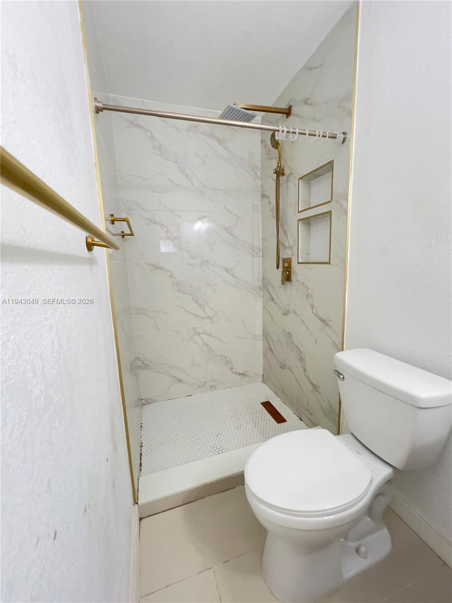 2761 Southwest 33rd Court, Unit A Miami, FL 33133 - Photo 8 of 22 a bathroom with a toilet and a shower