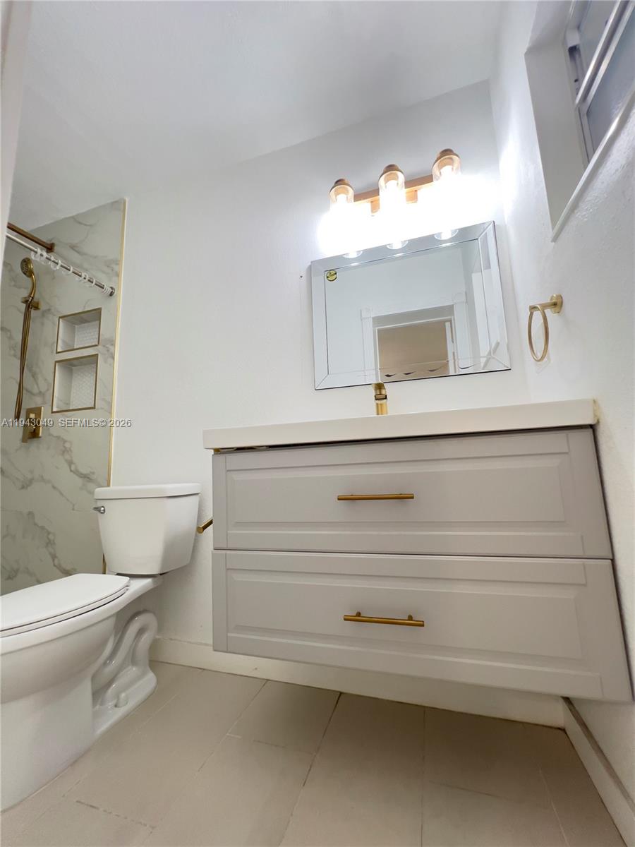 2761 Southwest 33rd Court, Unit A Miami, FL 33133 - Photo 10 of 22 a bathroom with a sink and a toilet