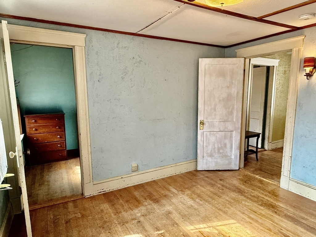 18 Spring Street Lexington, MA 02421 - Photo 12 of 21 a view of a hallway with wooden floor and closet