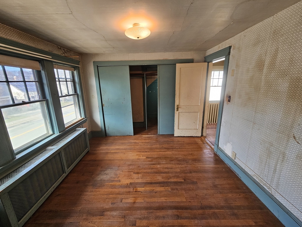 18 Spring Street Lexington, MA 02421 - Photo 13 of 21 a big room with wooden floor and windows