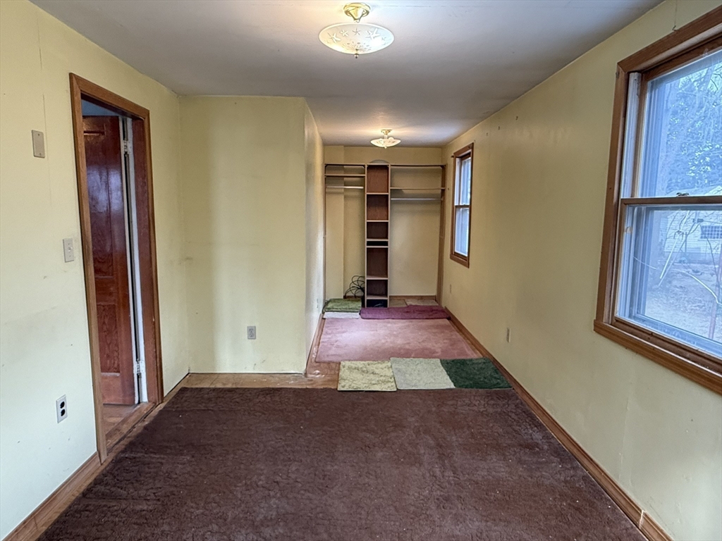 18 Spring Street Lexington, MA 02421 - Photo 14 of 21 wooden floor in an empty room with a window