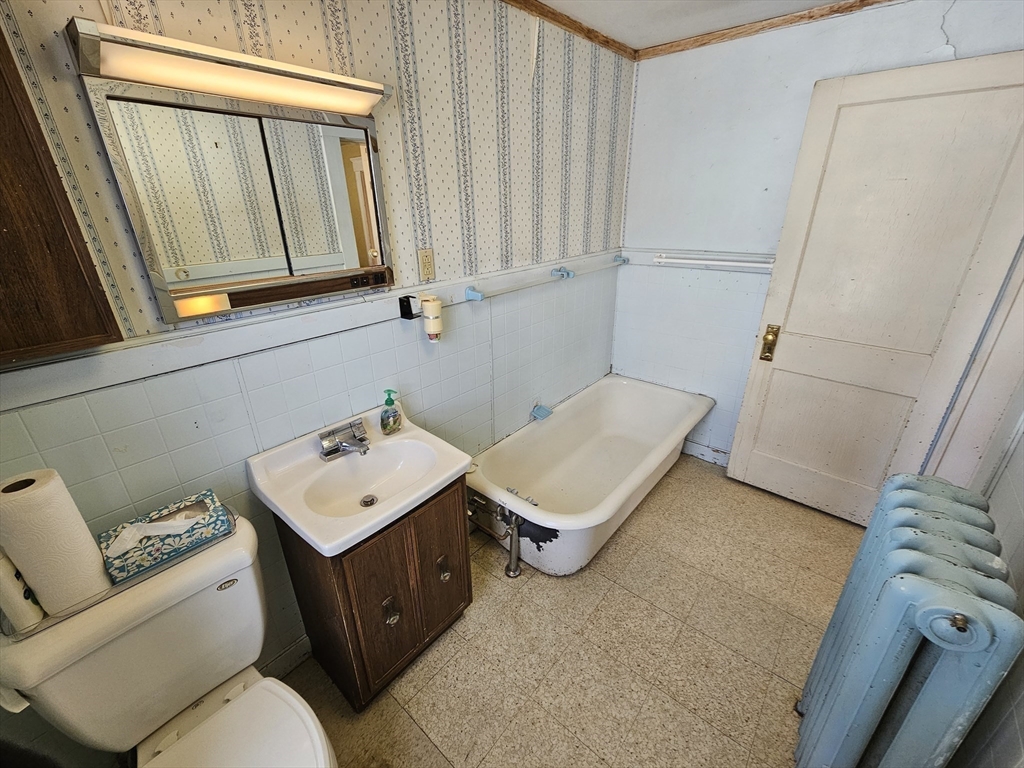 18 Spring Street Lexington, MA 02421 - Photo 16 of 21 a bathroom with a sink toilet and mirror