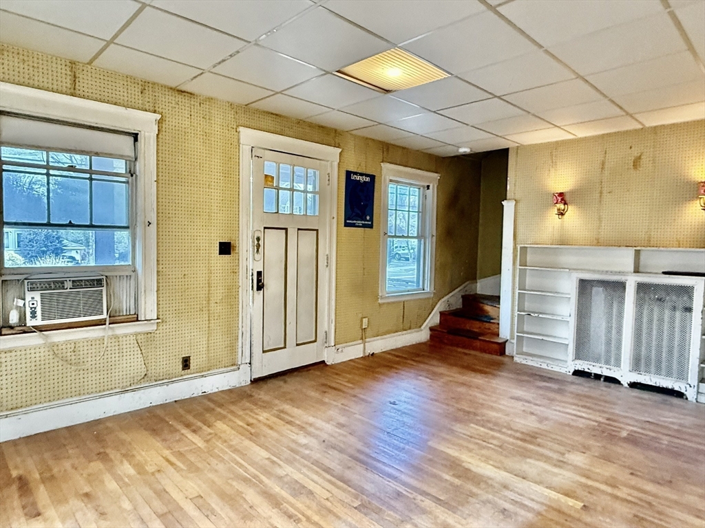 18 Spring Street Lexington, MA 02421 - Photo 4 of 21 an empty room with wooden floor and windows