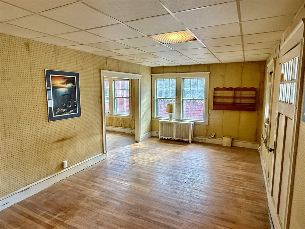 18 Spring Street Lexington, MA 02421 - Photo 6 of 21 a view of a livingroom with wooden floor and a bathroom