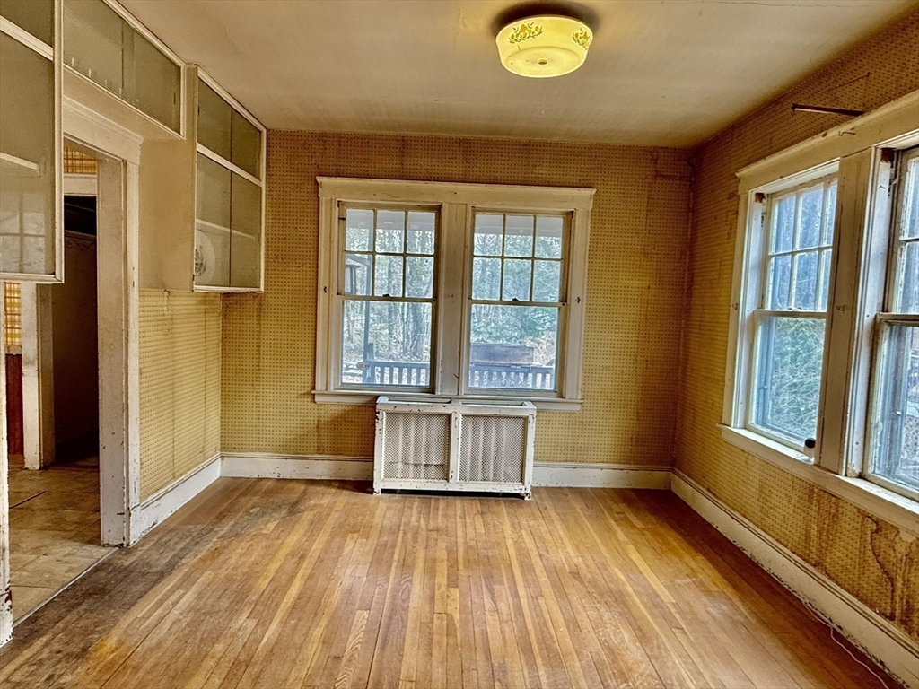 18 Spring Street Lexington, MA 02421 - Photo 7 of 21 a view of an empty room with wooden floor and a window