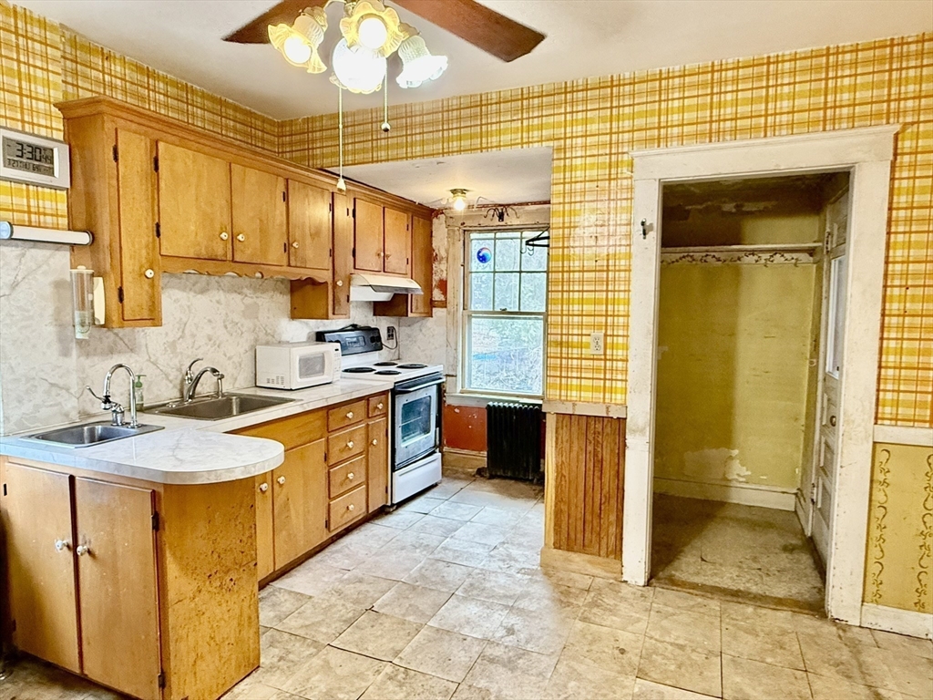18 Spring Street Lexington, MA 02421 - Photo 9 of 21 a kitchen with stainless steel appliances granite countertop a sink and cabinets