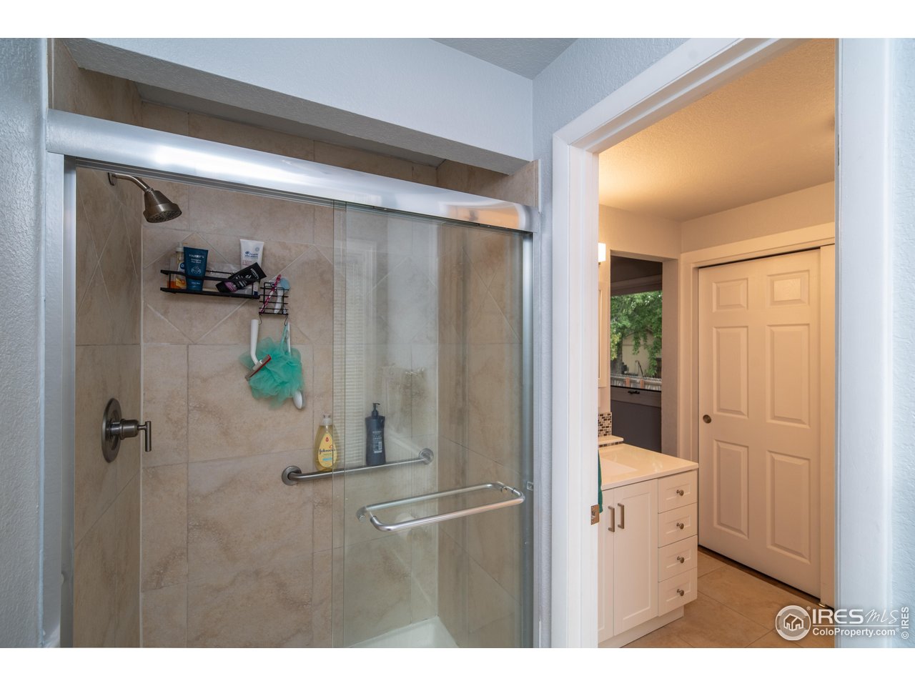 10879 West 65th Way Arvada, CO 80004 - Photo 25 of 39 a bathroom with a shower and a sink