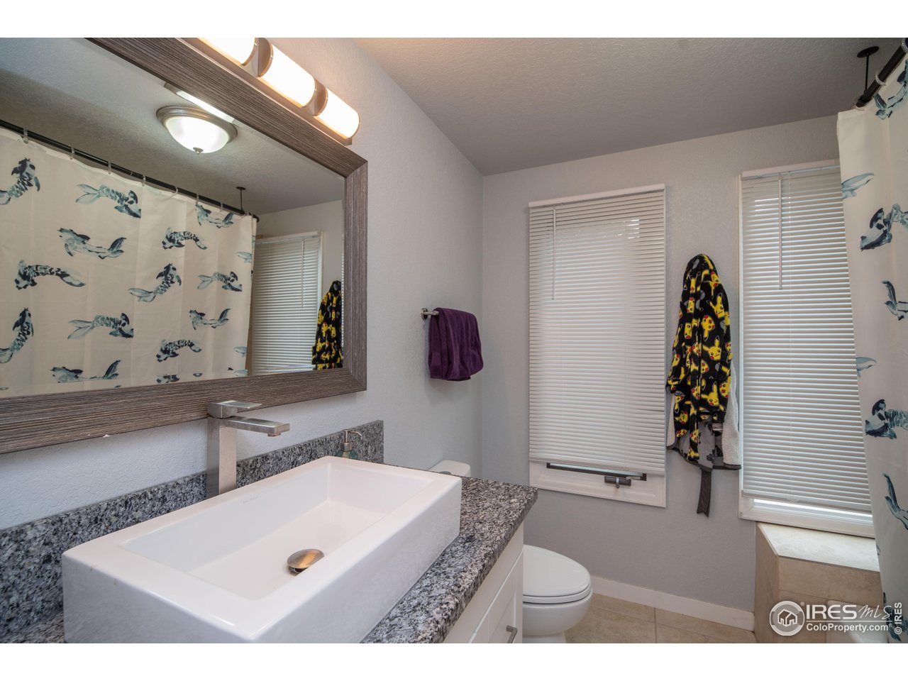 10879 West 65th Way Arvada, CO 80004 - Photo 27 of 39 a bathroom with a tub sink and mirror
