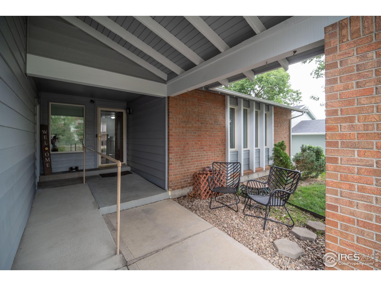 10879 West 65th Way Arvada, CO 80004 - Photo 3 of 39 a backyard of a house with outdoor seating