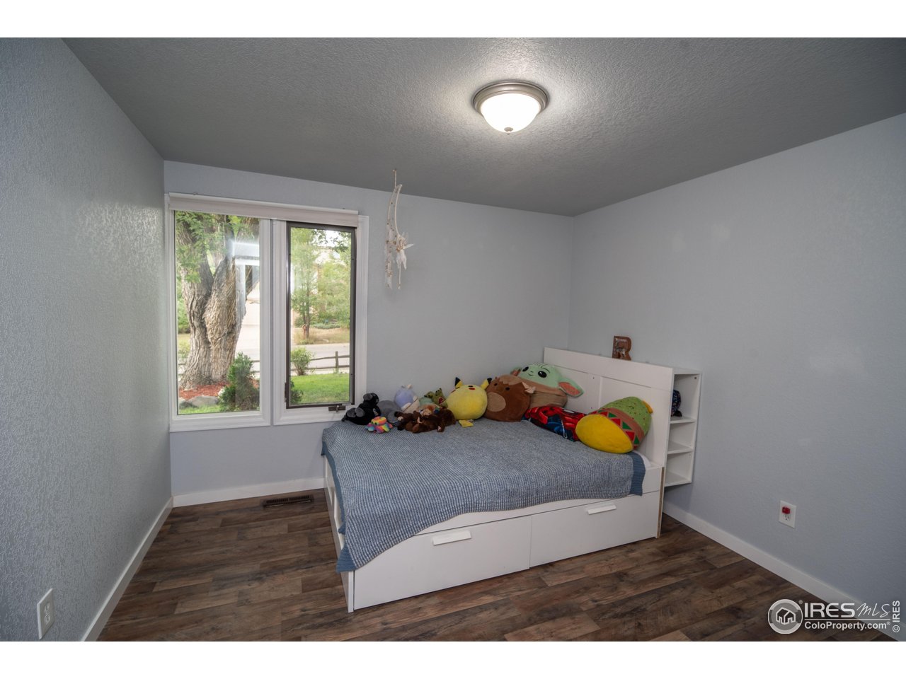 10879 West 65th Way Arvada, CO 80004 - Photo 31 of 39 a bedroom with a bed and a window