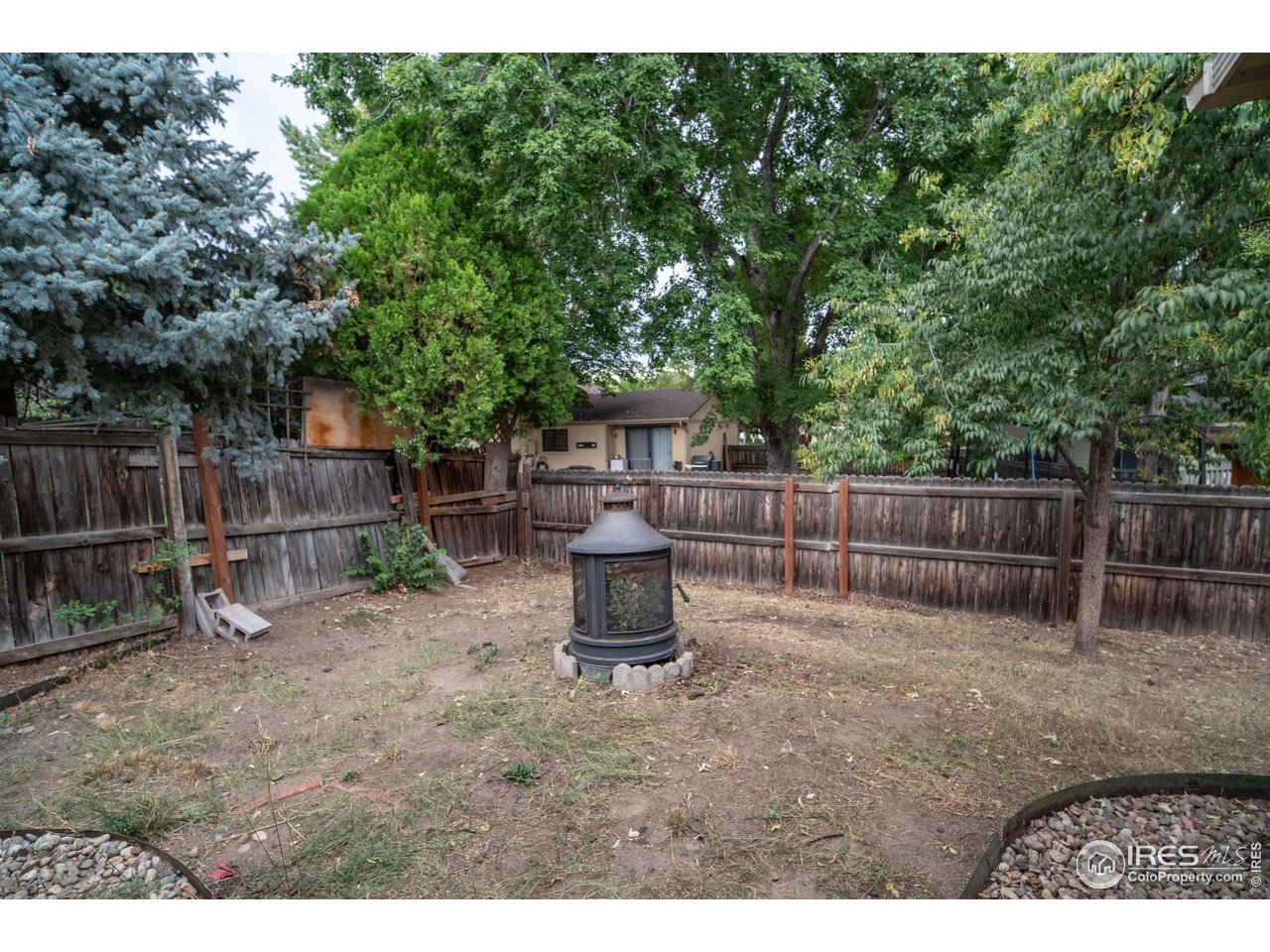 10879 West 65th Way Arvada, CO 80004 - Photo 34 of 39 a view of a backyard with wooden fence
