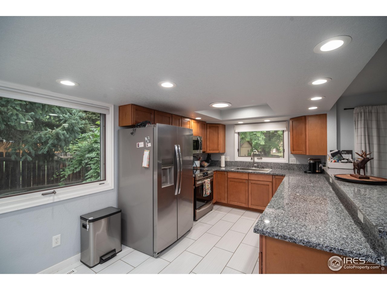 10879 West 65th Way Arvada, CO 80004 - Photo 4 of 39 a kitchen with refrigerator and window