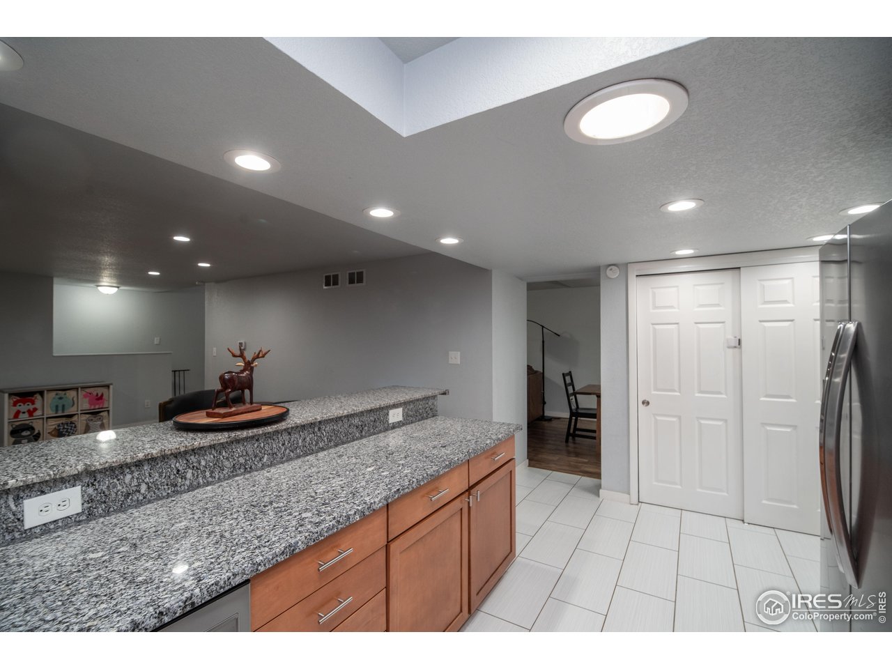 10879 West 65th Way Arvada, CO 80004 - Photo 5 of 39 a kitchen with stainless steel appliances granite countertop a sink and cabinets