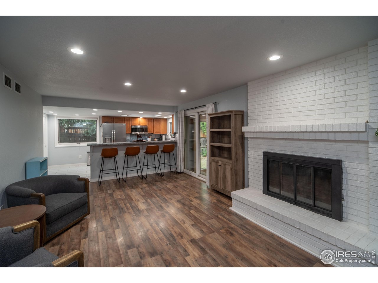 10879 West 65th Way Arvada, CO 80004 - Photo 8 of 39 a living room with furniture and a fireplace