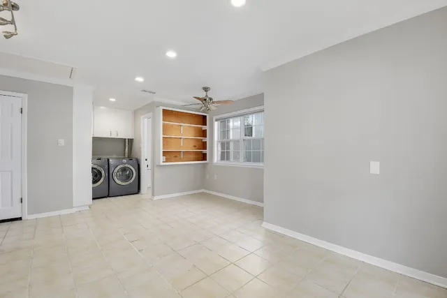 an empty room with windows and closet