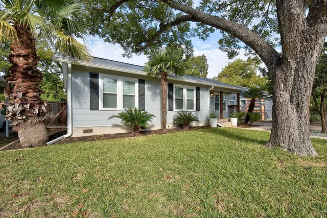 a front view of house with yard and green space