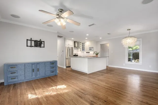 a view of kitchen and hall with wooden floor
