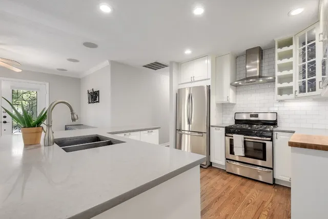 a kitchen with granite countertop a stove and a refrigerator