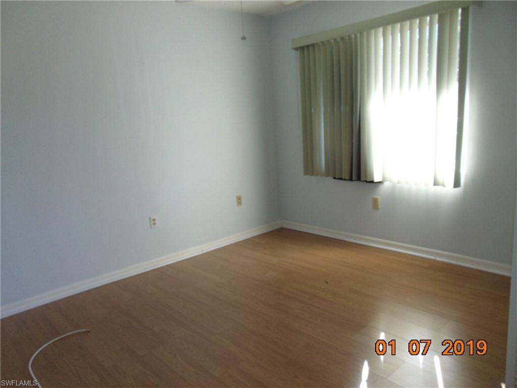 5685 Whitaker Road, Unit C102 Naples, FL 34112 - Photo 4 of 10 an empty room with windows