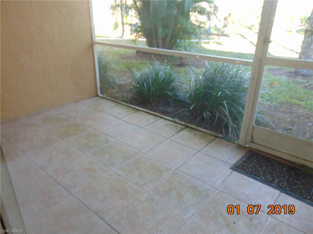 5685 Whitaker Road, Unit C102 Naples, FL 34112 - Photo 8 of 10 a view of a room with a floor to ceiling window and garden view