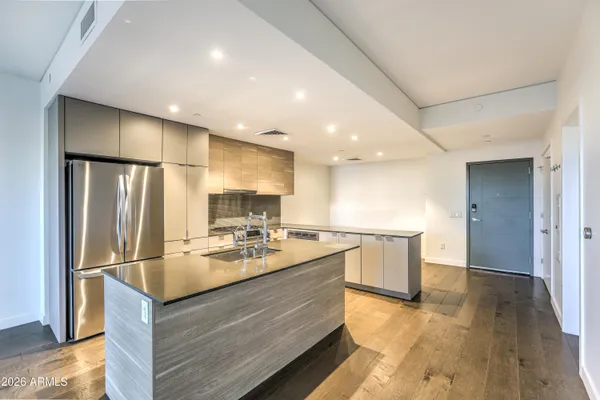 a kitchen with kitchen island a sink appliances and cabinets