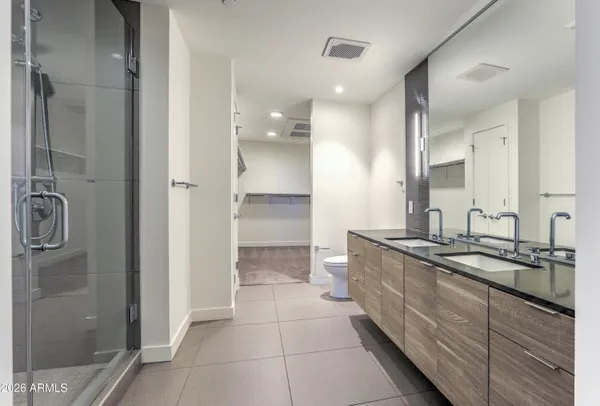 a bathroom with a granite countertop sink mirror and double