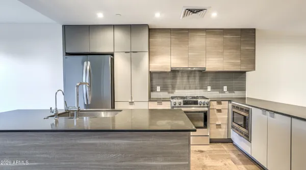a view of a kitchen with a sink and cabinets