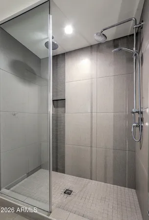 a bathroom with a shower and a glass door