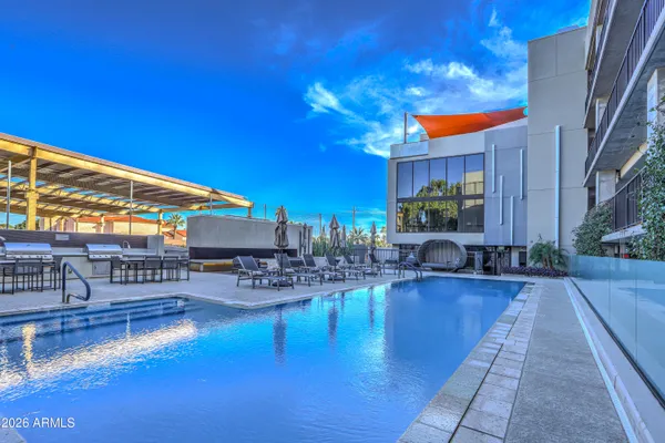 a living room with patio furniture and a fireplace
