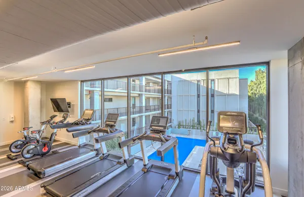 a view of a workspace with furniture and floor to ceiling window