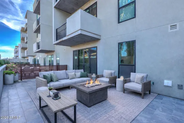 a living room with furniture and a potted plant