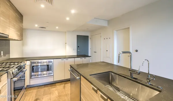 a kitchen with a sink and a stove top oven