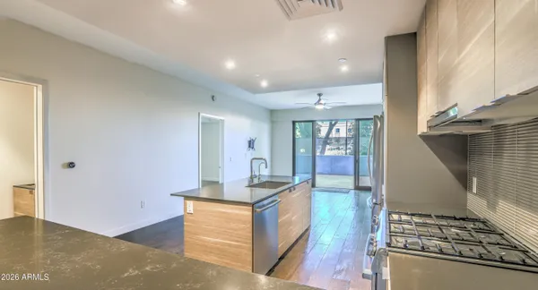 a kitchen with sink refrigerator and stove