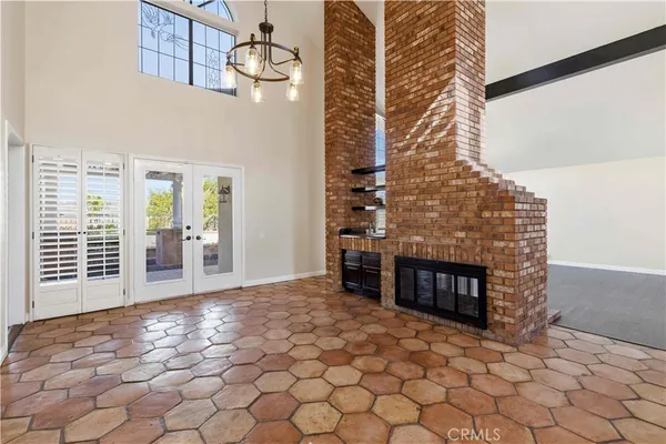 a view of a livingroom with wooden floor and a fireplace