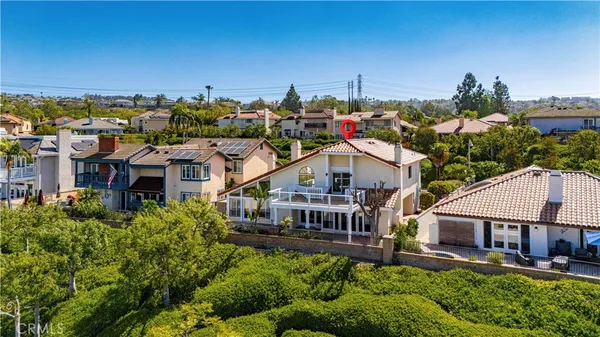 an aerial view of a house with a big yard and potted plants