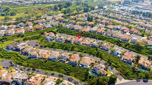 an aerial view of residential houses with outdoor space and swimming pool