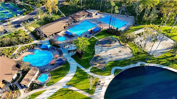 an aerial view of a pool patio chairs and fire pit