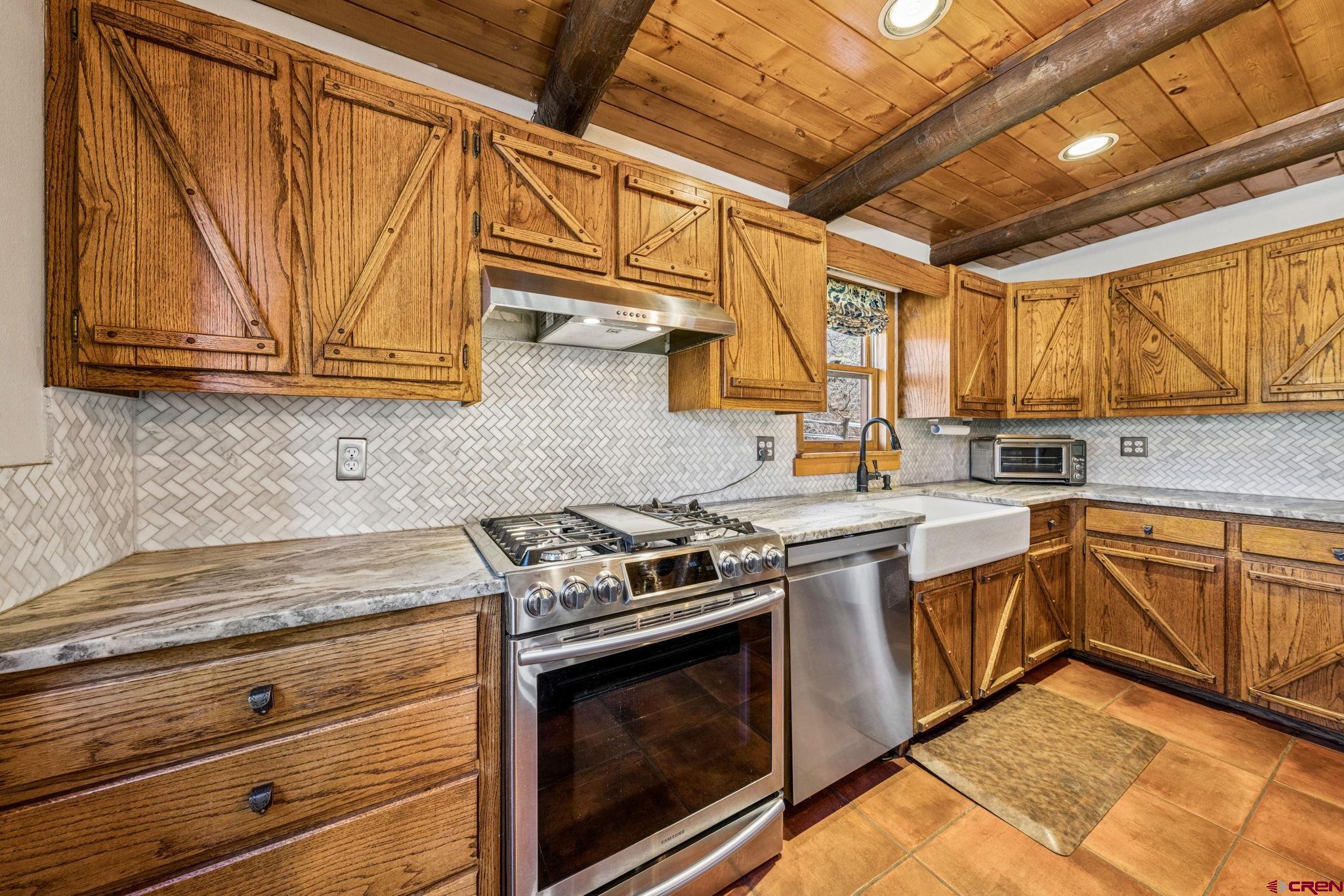 511 High Trails Drive Durango, CO 81301 - Photo 11 of 45 a kitchen with stainless steel appliances granite countertop a stove and a sink