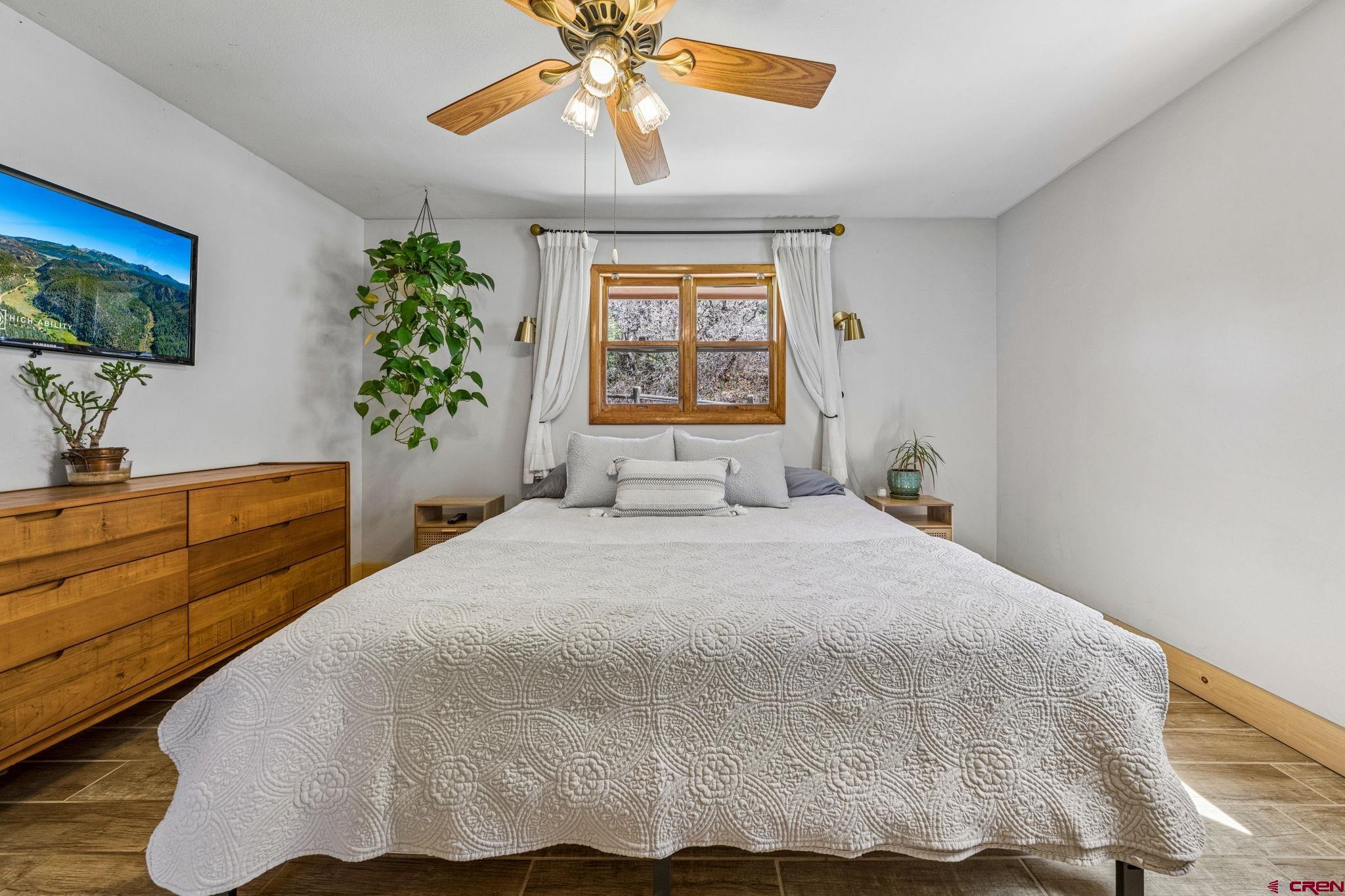 511 High Trails Drive Durango, CO 81301 - Photo 17 of 45 a bedroom with a bed and a flat screen tv