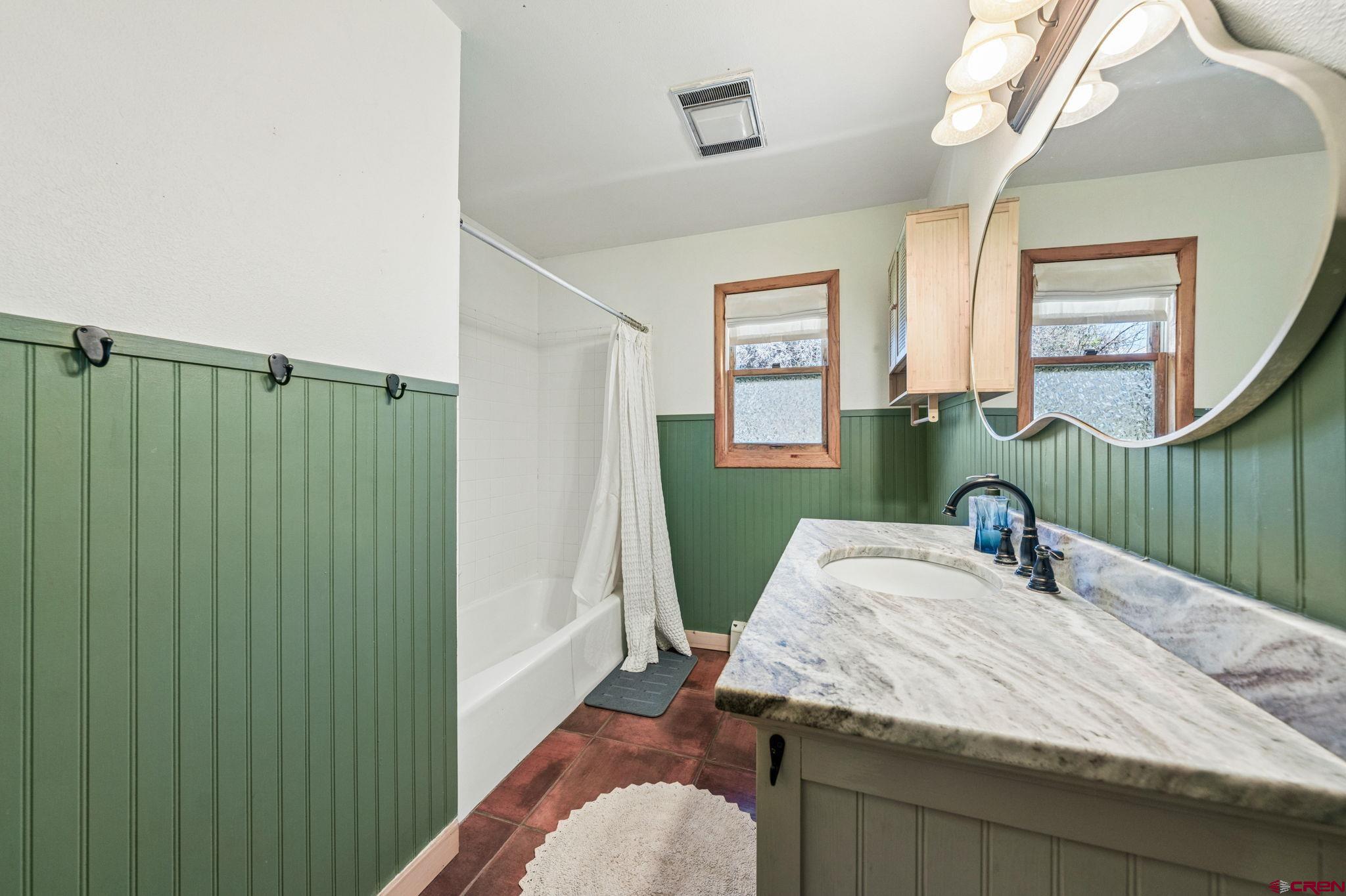511 High Trails Drive Durango, CO 81301 - Photo 20 of 45 a bathroom with a granite countertop sink and a mirror