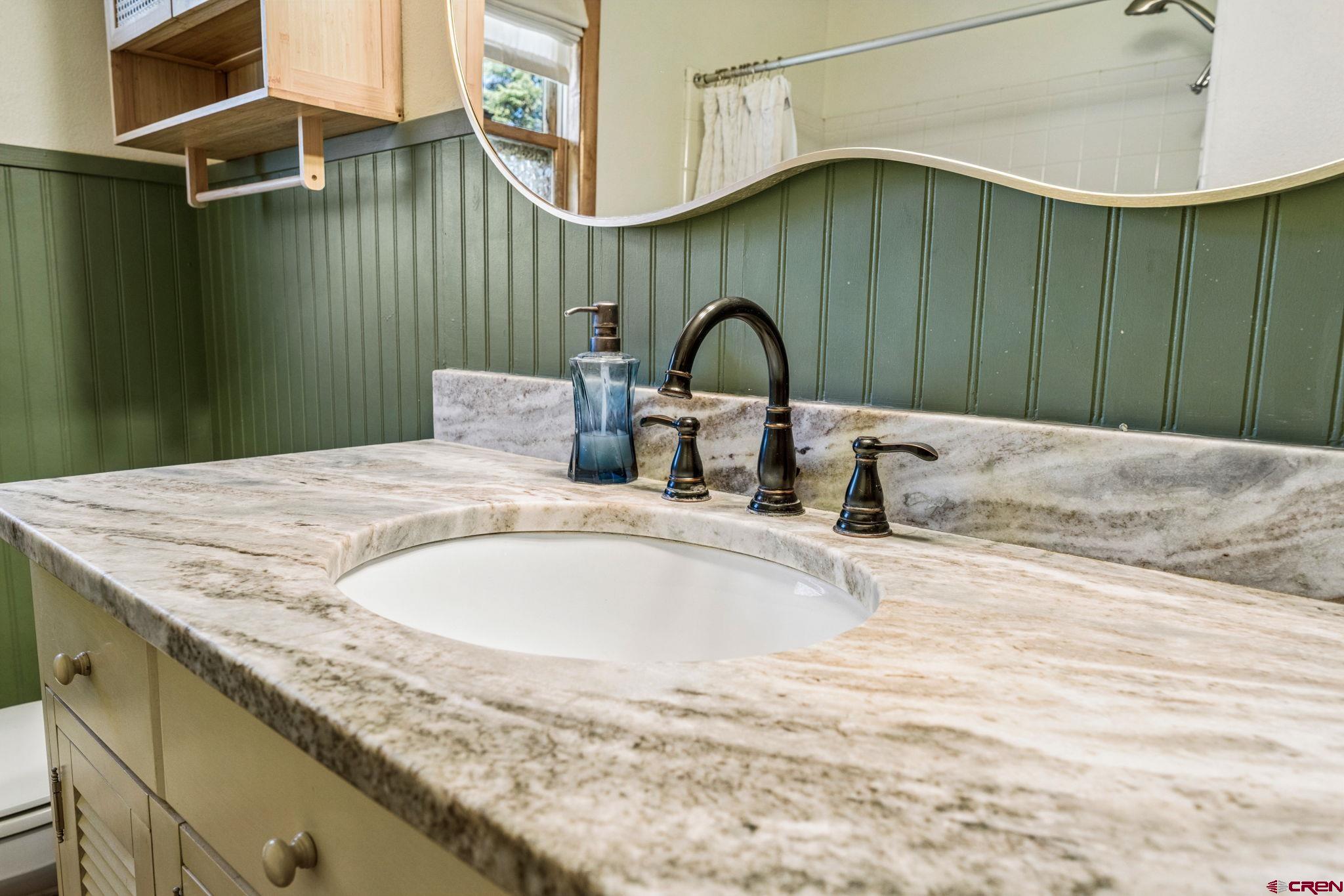 511 High Trails Drive Durango, CO 81301 - Photo 22 of 45 a bathroom with a granite countertop sink and a mirror