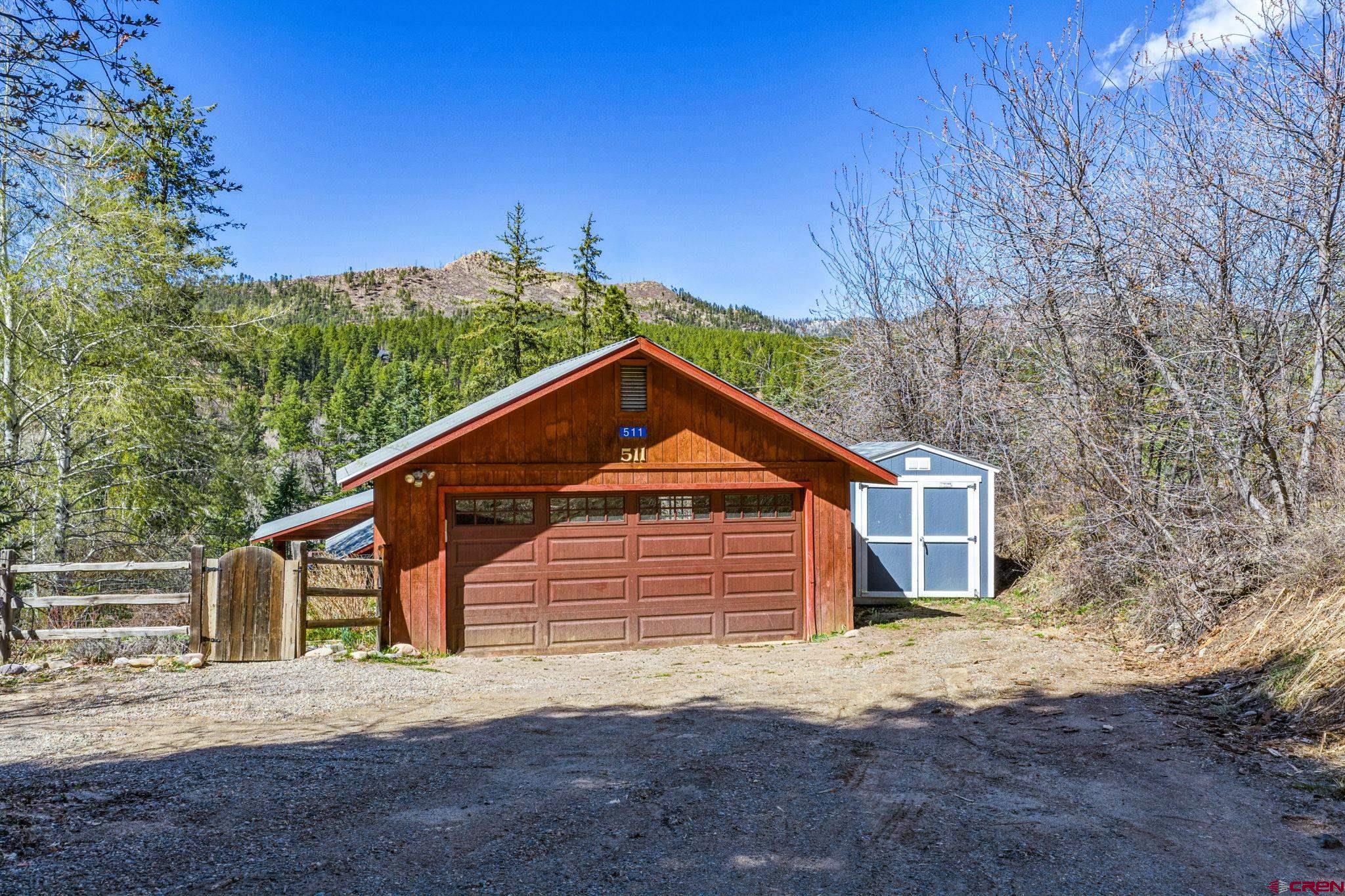 511 High Trails Drive Durango, CO 81301 - Photo 30 of 45 a front view of a house with a yard and garage