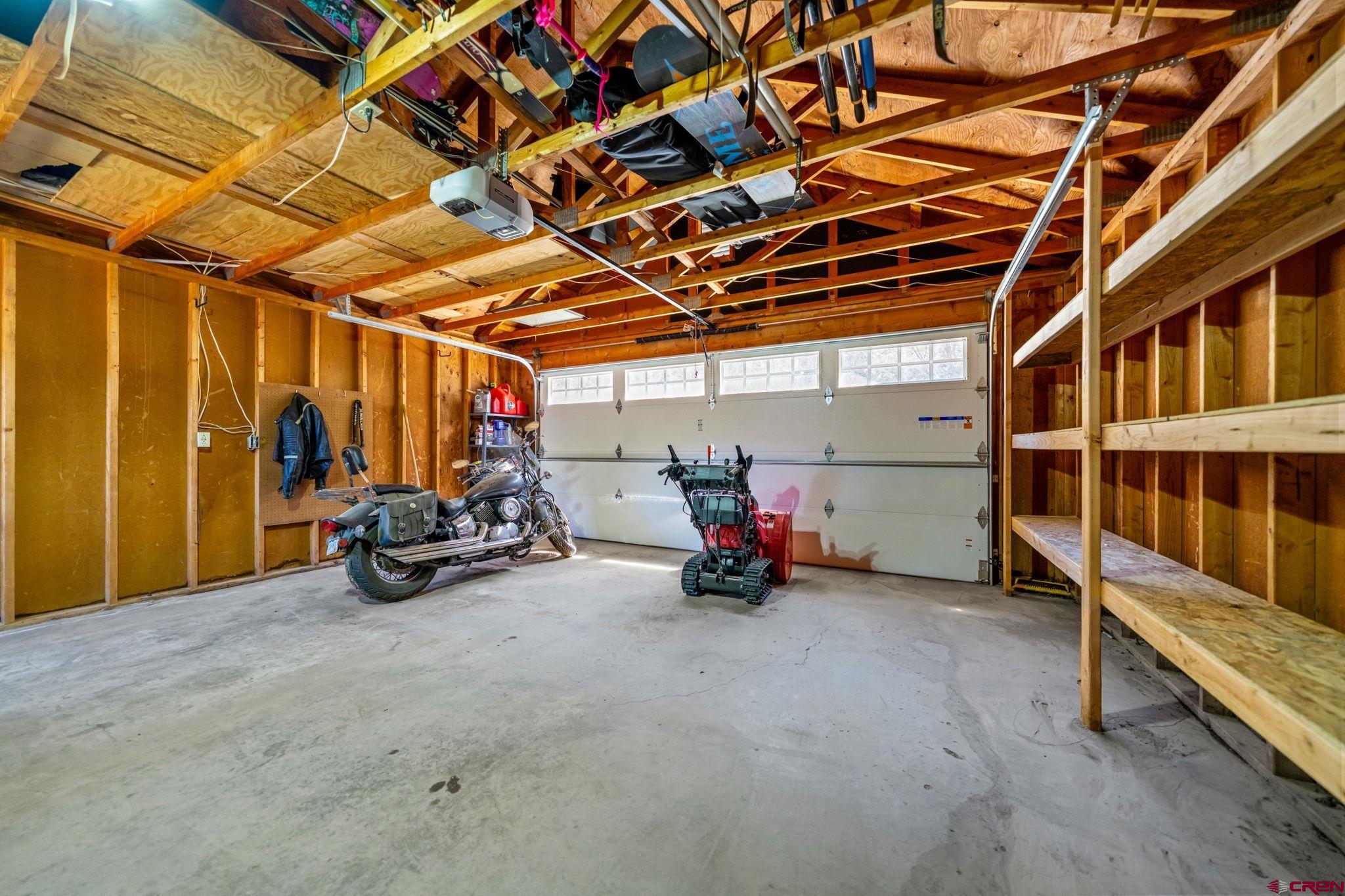 511 High Trails Drive Durango, CO 81301 - Photo 32 of 45 a view of a garage with wooden table and chairs