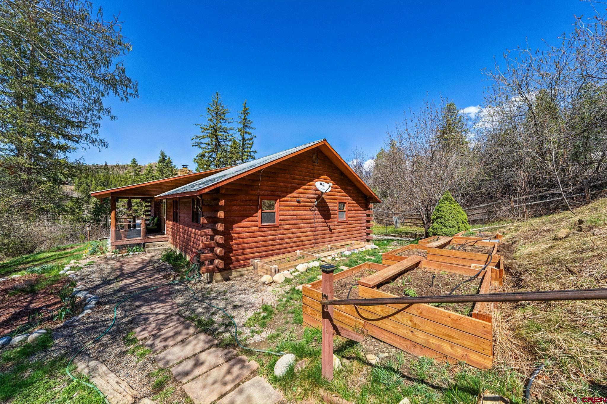 511 High Trails Drive Durango, CO 81301 - Photo 39 of 45 a backyard of a house with wooden deck and outdoor seating