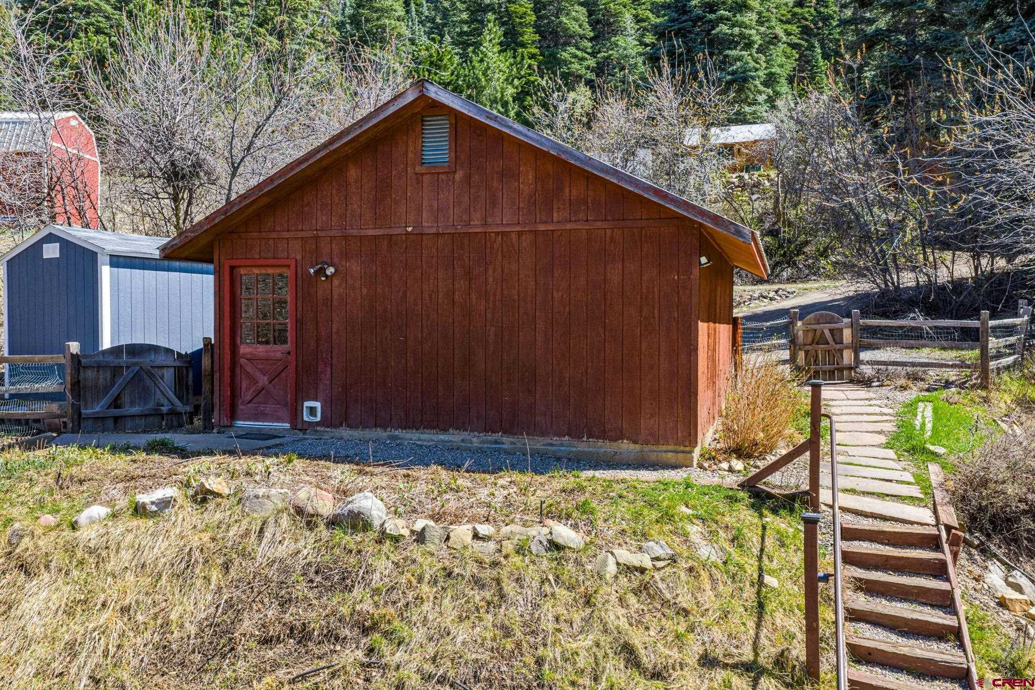 511 High Trails Drive Durango, CO 81301 - Photo 40 of 45 a view of a backyard with wooden fence and large trees